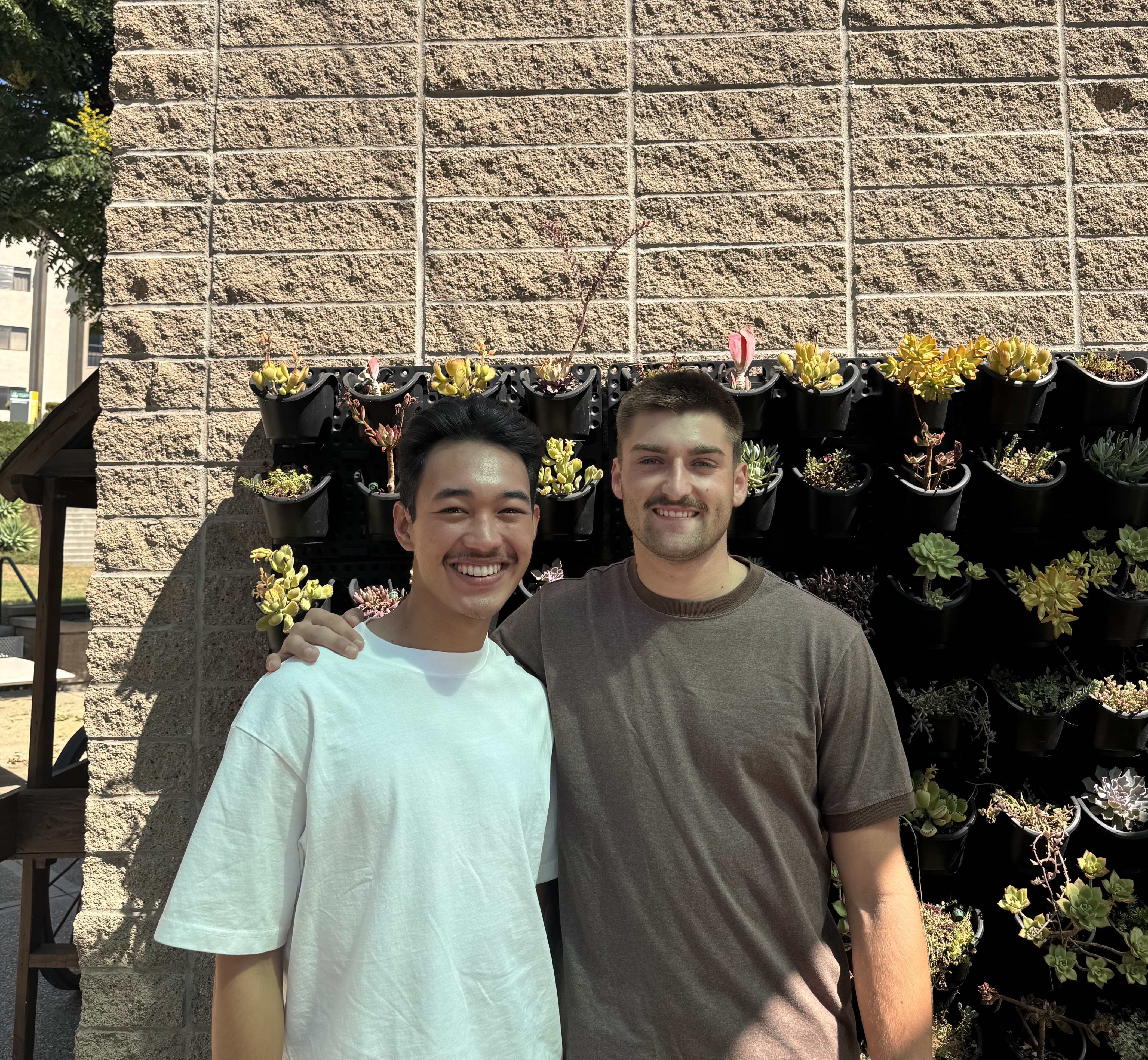 ASCUI President, Brody Collins, and ASCUI Communications Director Jai Viela posing for a picture outside of CSLD